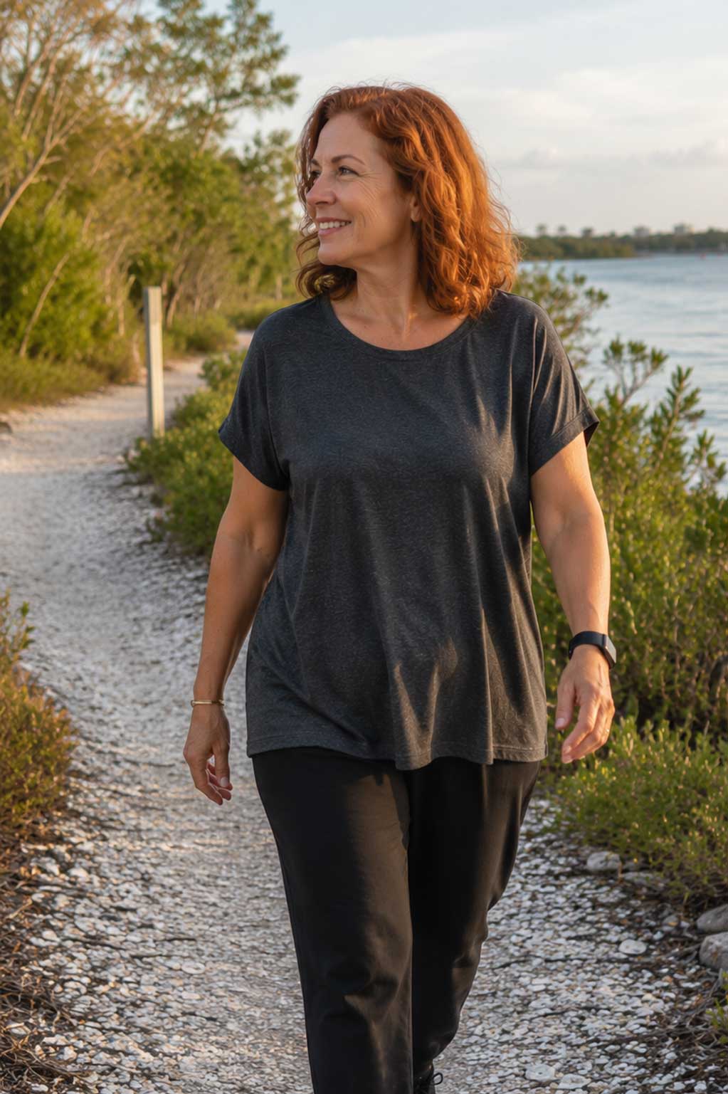 Guest enjoying a peaceful waterfront walk during a Weight Crafters wellness retreat.