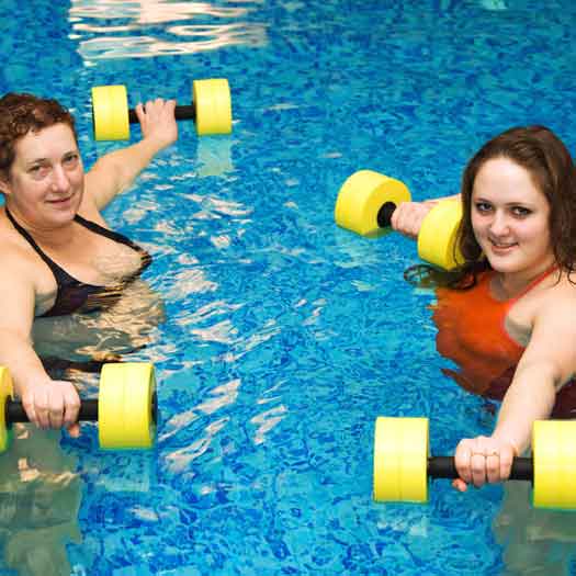 Weight loss camp clients doing low impact water exercises at Weight Crafters.