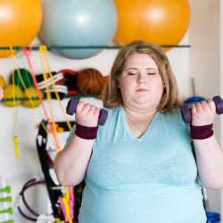 An obese female fat farm client exercising in our newly rennovated fitness center at Weight Crafters.