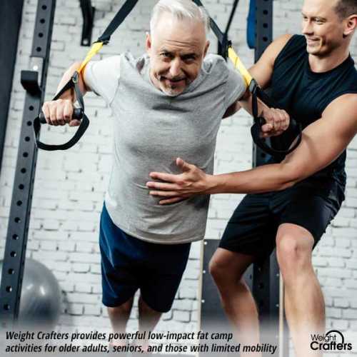 An older male client doing suspension training at the Weight Crafters fat camp program.